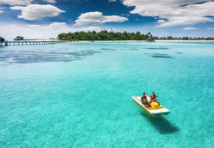 Couple-on-a-pedalo-boat-is-enjoying-the-turquoise-waters-of-the-tropical-Maldives